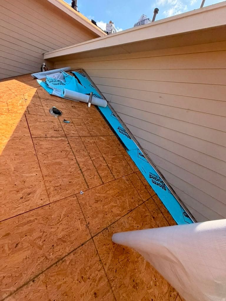 Fresh decking with StormGuard leak barrier run tight against a sidewall